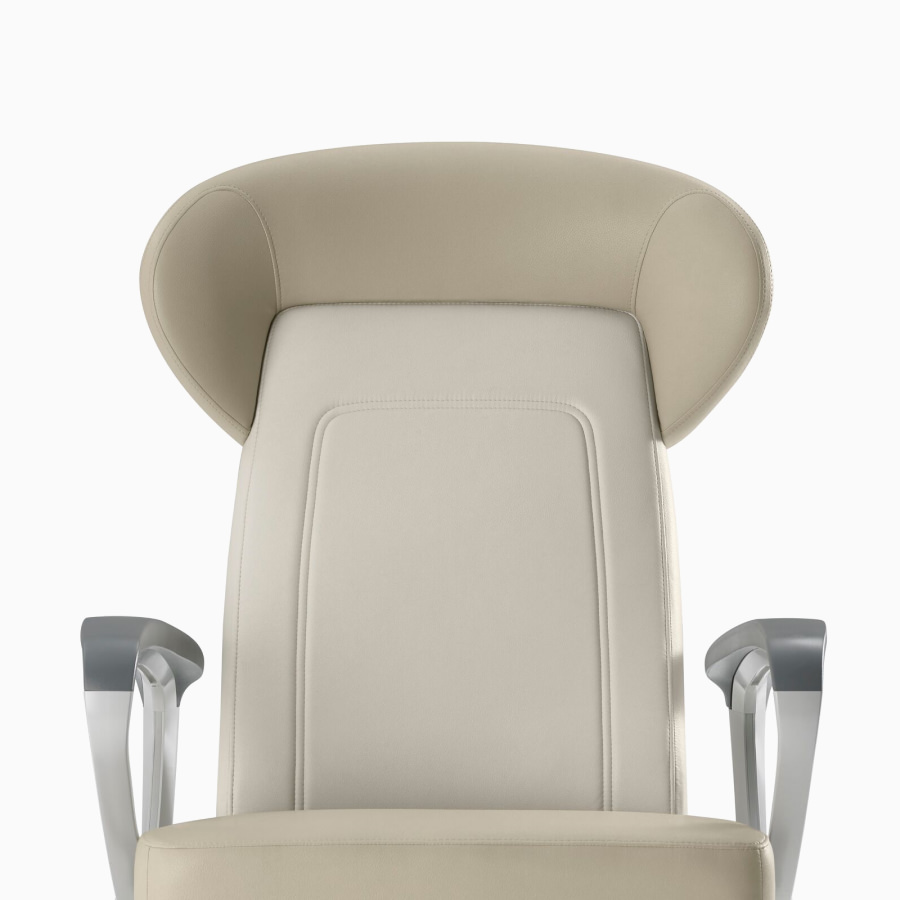 Nemschoff Ava Recliner with wingback in two beige upholsteries, viewed from the front angle.