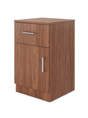 A Nemschoff Bedside Cabinet with one drawer and a bottom door in a medium walnut finish with satin nickel terra pulls and a full base.