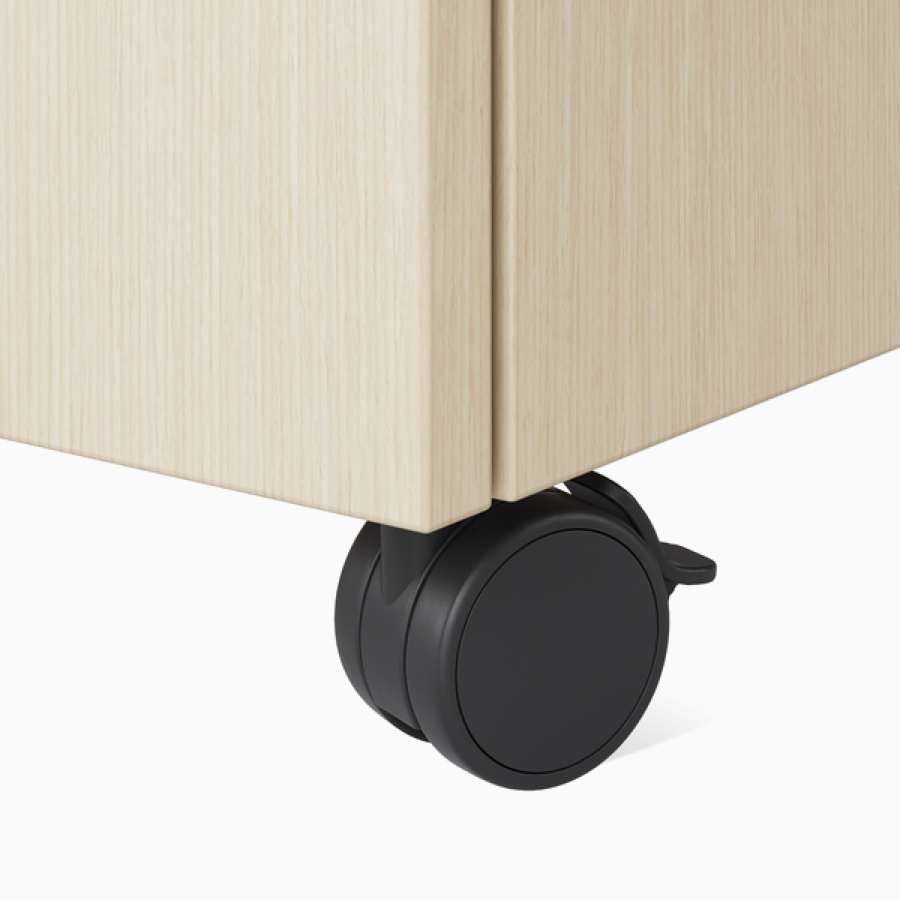 A close-up view of the locking caster on a Nemschoff Bedside Cabinet.