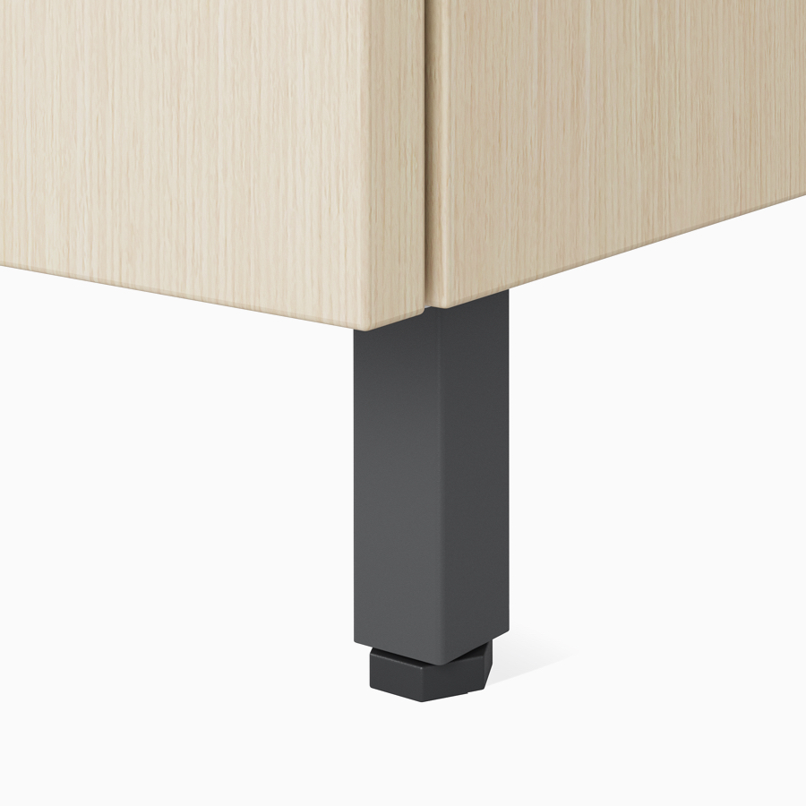 A close-up view of the raised metal leg on a Nemschoff Bedside Cabinet.