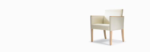 A three-quarter view of a Brava 862 Chair with maple frame, maple arm caps, and white textile.