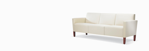A Brava Classic Lounge Sofa with white textile and upholstered arm caps.