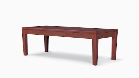 A Brava Table with a solid maple frame and veneer top in a red-toned finish.