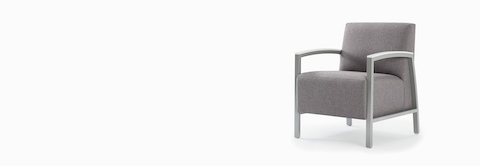 Front three-quarter view of a gray Brava modern lounge chair with solid surface arm caps. Front three-quarter view of a gray Brava modern lounge chair with solid surface arm caps.