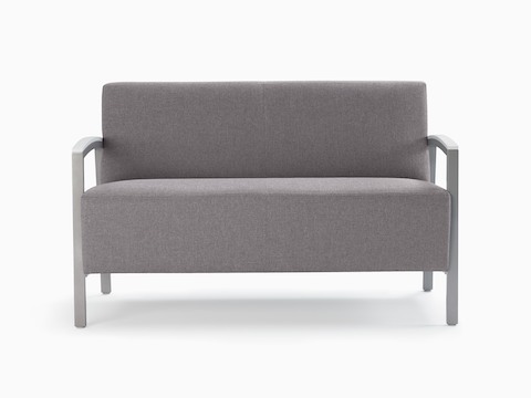 Front view of a gray Brava Modern Lounge Seating settee with solid surface arm caps.