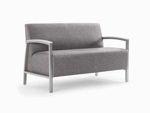 Front three-quarter view of a gray Brava Modern Lounge Seating settee with solid surface arm caps.