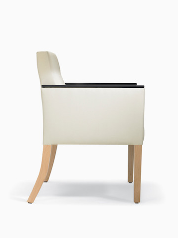 A side view of a Brava 862 Chair in white textile with urethane arm caps and maple legs.