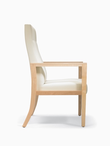 A side view of a Brava 863 high back patient chair in white textile with open maple wood arms.