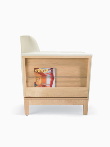 A side view of a Brava Platform Chair with literature storage in white textile with maple base.