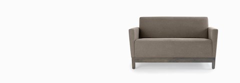 Front view of a gray Brava Platform Lounge System two-seat sofa with upholstered arms on a wood base. Front view of a gray Brava Platform Lounge System two-seat sofa with upholstered arms on a wood base.