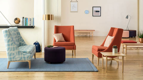 Waiting area with a grouping of a Nemschoff  Iris Settee in a light blue patterned upholstery with two Nemschoff Iris Lounge Chairs in an orange upholstery with a Nemschoff Steps Ottoman in a purple upholstery with a Nemschoff Hemlock Side Table.