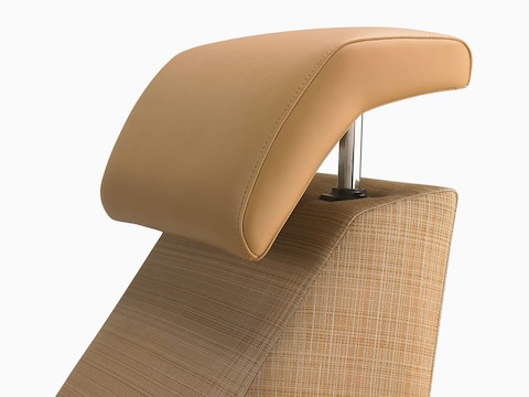 A detail of an extended headrest in a tan upholstery on a Nemschoff Consoul Recliner.