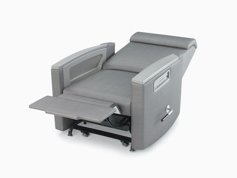 Three-quarter view of Consoul Reclining Glider with footrest extended showing glider handle in full recline position. Pewter urethane arm caps and in-arm storage. Upholstered in Maharam Stature Stealth.