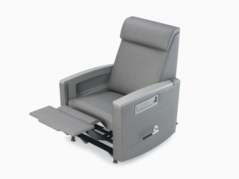 Three-quarter view of Consoul Reclining Glider with footrest extended showing glider handle. Pewter urethane arm caps and in-arm storage. Upholstered in Maharam Stature Stealth.