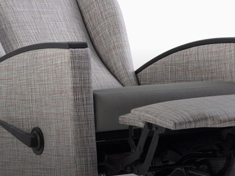 Detail view of a Culla Reclining Glider with gray patterned textile and gray textile seat, viewed in a reclined position.