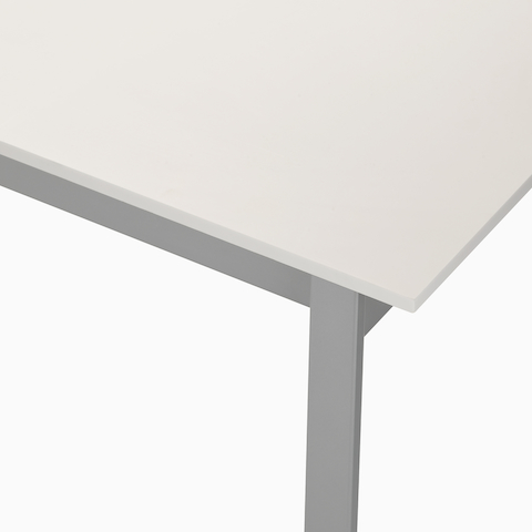 Detail of the top of an Easton Coffee Table with a glacier white Corian top and metallic silver leg.