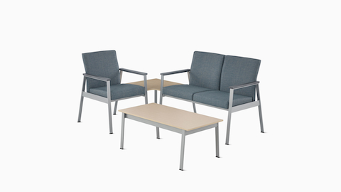 Easton Side Chair in blue with a silver frame connected by a corner table in clear on ash to Easton two-seat Multiple Seating in blue, and an Easton Coffee Table with a clear on ash laminate top and sliver frame.