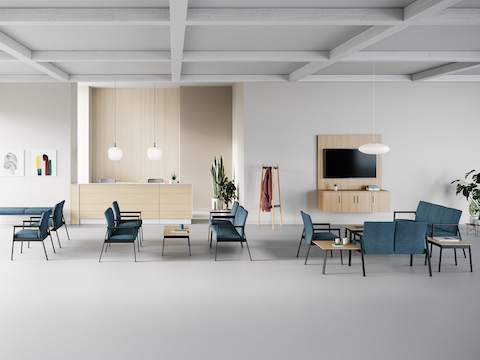 A group of Easton seating products with a Patient Chair, Plus Chair, and Side Chair in green upholstery and black frame and a three-seat Multiple Seating and Easy Access Chair in blue upholstery and silver frame.