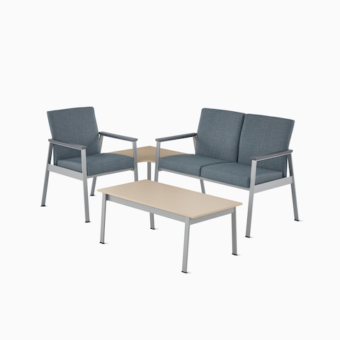 Easton Side Chair in blue with a silver frame connected by a corner table in clear on ash to Easton two-seat Multiple Seating in blue, and an Easton Coffee Table with a clear on ash wood laminate top and sliver frame.