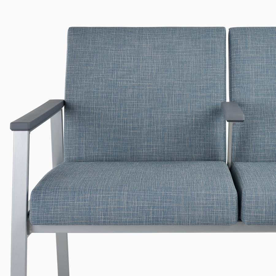Front close-up of Easton two-seat Multiple Seating with intervening arms in blue upholstery, silver frame, and slate gray arm caps.