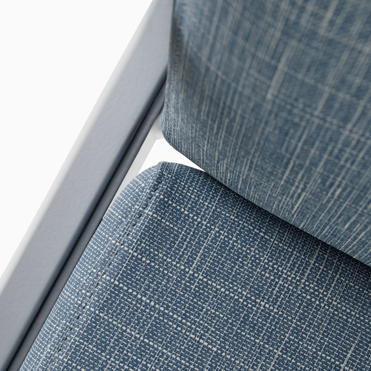 Detail of the clean-out gap in an Easton chair with slate gray arms and light blue upholstery.