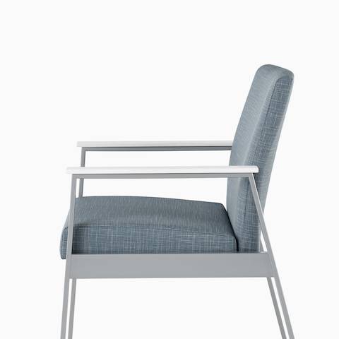 Side view of an Easton Side Chair with blue upholstery, metallic silver four-leg base, and glacier white Corian arm caps. Side view of an Easton Side Chair with blue upholstery, metallic silver four-leg base, and glacier white Corian arm caps.