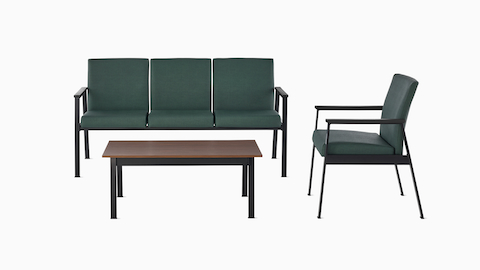 An Easton three-seat Multiple Seating and Easton Side Chair, both in green upholstery and black frames, sit across from an Easton Coffee Table with a medium-matte walnut laminate top and black frame. An Easton three-seat Multiple Seating and Easton Side Chair, both in green upholstery and black frames, sit across from an Easton Coffee Table with a medium-matte walnut laminate top and black frame.