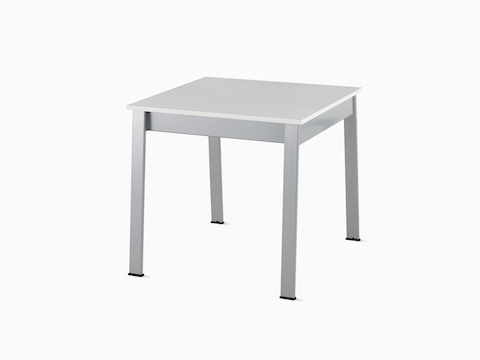 Angled view of an Easton Side Table with a glacier white Corian top and metallic silver legs.