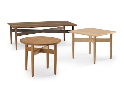 An arrangement of Hemlock tables, including a coffee table in walnut, a square end table in maple, and a round end table in oak.