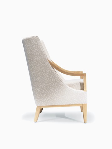 Side view of Nemschoff Iris Lounge Chair in a cream upholstery with light wood arms, base, and legs.