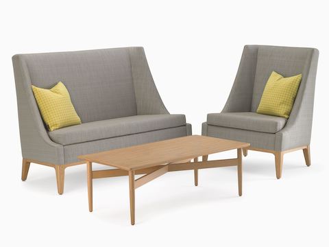 An Iris Lounge Chair and Settee in gray textile with maple legs and a Hemlock Coffee Table in maple.
