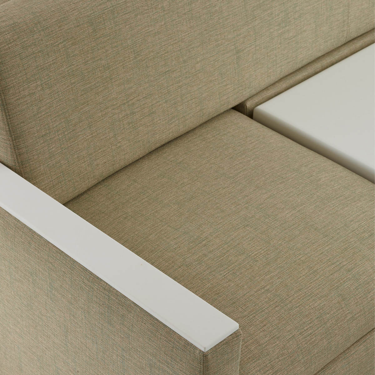 Detail of the clean out design on a Nemschoff Merge 2 Flop Sofa in a beige upholstery with a white center table and a natural maple base.