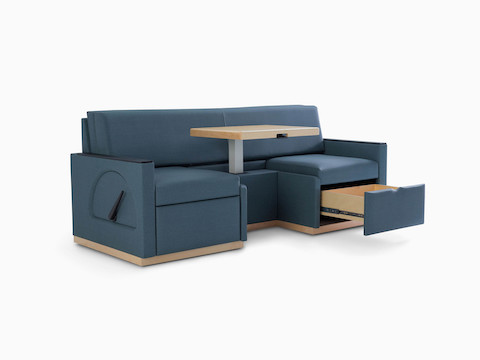 Nemschoff Merge 2 Flop Sofa in dark blue textile with light wood table and black solid surface arm caps.