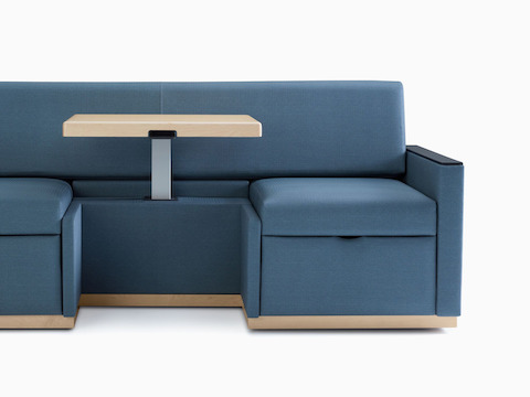 Nemschoff Merge 2 Flop Sofa in dark blue textile with light wood table and black solid surface arm caps.