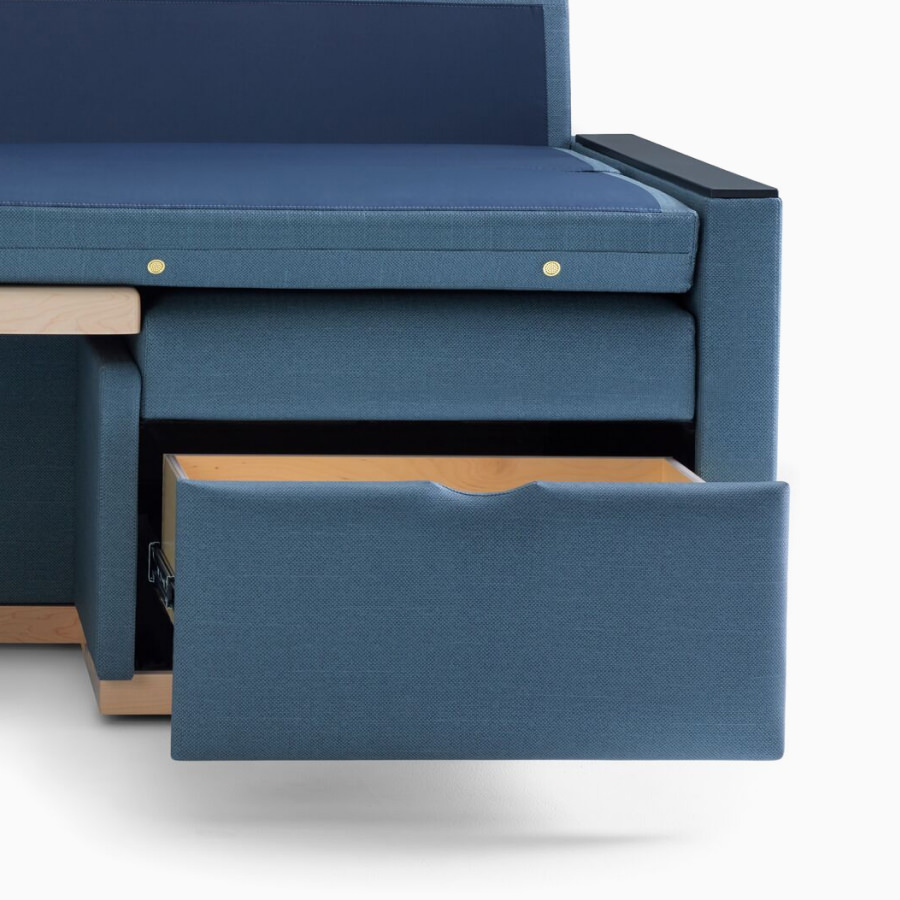 Nemschoff Merge 2 Flop Sofa in dark blue textile with black solid surface arm caps and a storage drawer behind the feet.