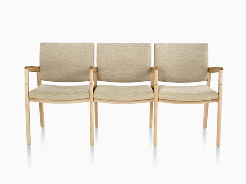 Monarch Multiple Seating three-seater with intervening arms and legs in tan textile with solid hardwood frame.