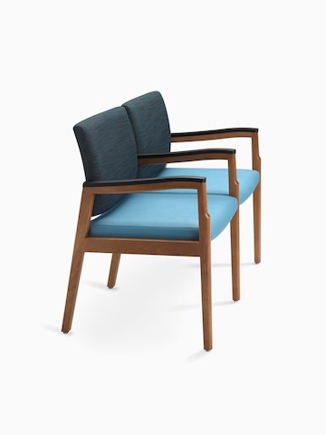 A side view of Monarch Multiple Seating two-seater with intervening arms and legs in blue textile with solid hardwood frame and urethane arm caps.