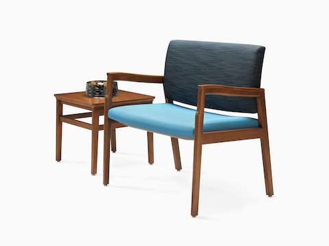 A Monarch Plus Chair in blue textile with solid hardwood frame and wood arm caps and a Monarch side table.