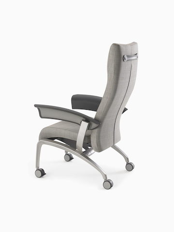 Nemschoff Nala Patient Chair in a gray upholstery and dark gray arms on white sweep from the back angle.