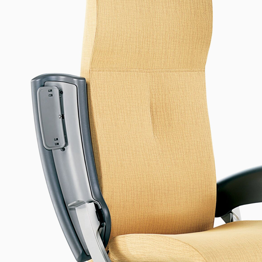 Nemschoff Nala Patient Chair in a yellow upholstery with and dark gray arms with one arm extended up for access to the seat, viewed from an angle.