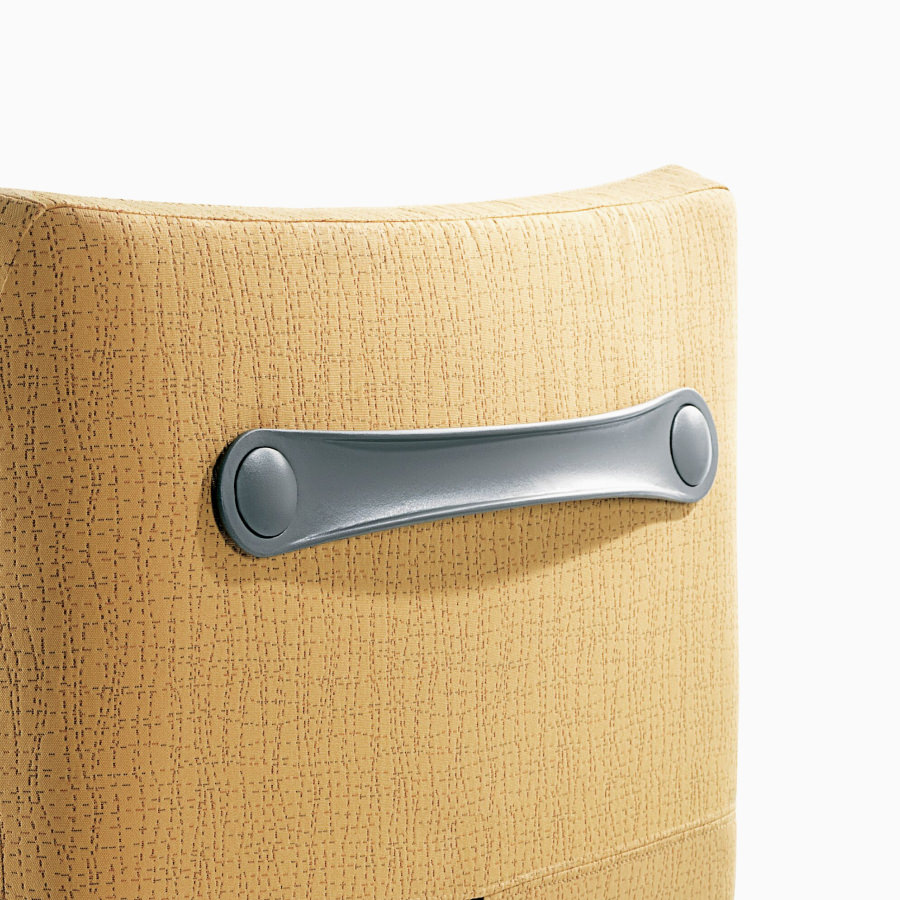Detail of the integral back handle on a Nemschoff Nala Patient Chair.