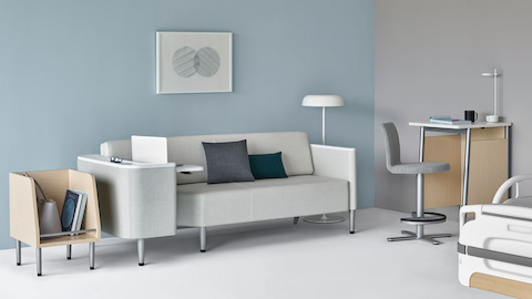 Patient room featuring the Nemschoff Palisade Flop Sofa in a gray fabric, next to a Nemschoff Palisade Tote, Nemschoff Palisade Daystand, and patient bed.