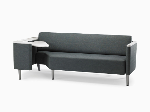 A Nemschoff Palisade Flop sofa in dark gray textile with white solid surface arms caps and white adjustable table with Durawrap top. A Nemschoff Palisade Flop sofa in dark gray textile with white solid surface arms caps and white adjustable table with Durawrap top.