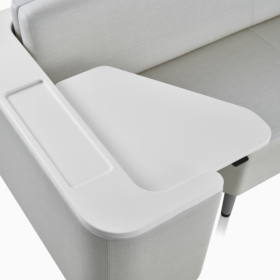 Detail view of the utility arm and height adjustable surface on a Nemschoff Palisade Flop Sofa on white sweep.
