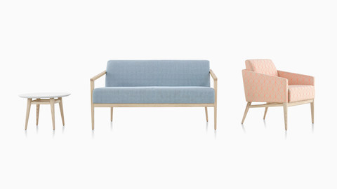 Three items from the Palisade collection: a small occasional table with white surface and wooden legs, a sofa with wooden arms, and the Palisade Lounge Chair with patterned pink and tan upholstery.