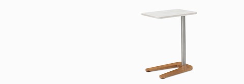A Palisade Mobile Table with a walnut base, silver legs, and a white top. A Palisade Mobile Table with a walnut base, silver legs, and a white top.