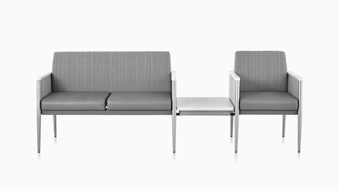 Front view of Nemschoff Palisade Multiple Seating with two seats on one side and a single seat on the other with a center height-adjustable table surface in the down position.