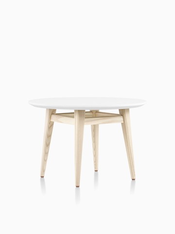 Three-quarter view of round Palisade Side Table with white surface and wood legs.