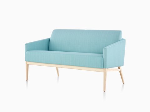 Three-quarter view of turquoise Palisade Sofa with wood legs.