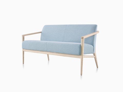 Three-quarter view of a light blue Palisade Sofa with wood legs.